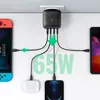 A UGREEN 65W GaN fast wall charger is shown plugged into a wall outlet, simultaneously charging a Nintendo Switch, a pair of wireless earbuds, and a smartphone. Produktbild-Vorschau