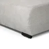 A close-up view of the bottom corner of a light beige upholstered sofa, showing the texture of the fabric and one of its black metal legs. Produktbild-Vorschau