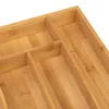 A close-up view of a wooden drawer organizer with multiple compartments. Podgląd zdjęcia produktu