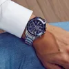 A person wearing a watch and jeans. Náhľad obrázku produktu