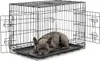 A dog is lying inside a metal dog crate. Náhled obrázku produktu