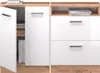 A close-up view of a white high-gloss cabinet with wooden accents, showing open doors and drawers. Náhled obrázku produktu