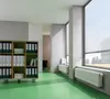 An office or commercial space with a bookshelf, windows, and radiators. Podgląd zdjęcia produktu