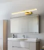 A modern bathroom vanity with a mirror and a gold light fixture above. Náhľad obrázku produktu