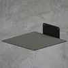 A square metal shelf mounted on a concrete wall. Produktbild-Vorschau