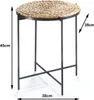 A round side table with a woven top and metal legs, shown with dimensions indicated by arrows and text. Produktbild-Vorschau