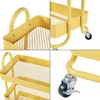 A collage of four close-up images showing details of a yellow metal kitchen trolley. Produktbild-Vorschau