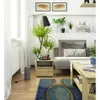 A modern living room scene with a couch, coffee table, and floor lamp. Podgląd zdjęcia produktu