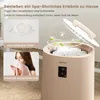 A towel warmer with aromatherapy features, showing a close-up of the aromatherapy holder and a woman smelling a towel. Anteprima dell’immagine prodotto