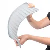 A person's hands are holding and bending a gray dish drying mat. Podgląd zdjęcia produktu