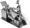 A metal sculpture of a dentist examining a patient, with a napkin holder on the side. Anteprima dell’immagine prodotto