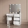 A white vanity table with a lighted mirror and a white stool in front of it, set against a light brown wall. Voir les images du produit