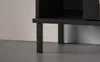 A close-up view of the black legs and bottom shelf of a piece of furniture. Produktbild-Vorschau