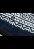 A close-up of a knitted fabric with a pattern and a brand tag. Náhled obrázku produktu