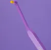 A close-up shot of a single purple interdental brush with a yellow tip against a solid purple background. Produktbild-Vorschau