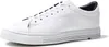 A white leather sneaker with a thick grey sole, shown from a side angle against a white background. Voir les images du produit