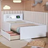 A child's bed with storage drawers and a headboard featuring a tablet and light. Produktbild-Vorschau