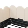 Close-up view of a bed frame with a beige upholstered headboard. Voir les images du produit
