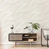 A living room scene featuring a credenza with decorative items and a chair. Produktbild-Vorschau