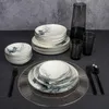 A table setting with a dinnerware set, glasses, and a pitcher. Anteprima dell’immagine prodotto