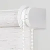 A close-up view of the mechanism and fabric of a roller blind. Podgląd zdjęcia produktu