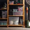 Storage shelves in a garage or utility room, filled with various storage containers and equipment. Náhľad obrázku produktu