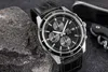 A close-up shot of a black Casio Edifice watch with a leather strap, resting on a dark, textured surface next to a rock. Produktbild-Vorschau