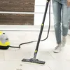 A person is using a steam cleaner on a tiled floor. Produktbild-Vorschau