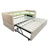 A beige sofa bed is shown partially opened, revealing its slatted mattress base and metal frame. The sofa has built-in shelving with LED lighting. Anteprima dell’immagine prodotto