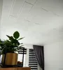 A room interior with a white paneled ceiling, a window with blinds, and a curtain. Anteprima dell’immagine prodotto