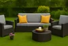 An outdoor furniture set on a grassy lawn with a hedge and bushes in the background. Produktbild-Vorschau