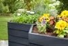 A raised garden bed filled with herbs and flowers in a garden setting. Anteprima dell’immagine prodotto