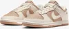 A pair of Nike Dunk Low Next Nature sneakers in beige and sail colors, shown from a diagonal front view on a white background. Produktbild-Vorschau