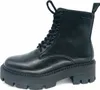 A black leather combat boot with a thick platform sole is shown against a white background. Náhľad obrázku produktu