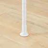 A close-up view of the base of a white adjustable pole standing on a light wood floor. Produktbild-Vorschau