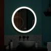 A round LED mirror above a sink in a bathroom. Voir les images du produit