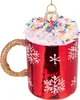 A close-up of a red glass Christmas ornament shaped like a mug with white snowflakes and a gold glitter handle, topped with white "whipped cream" and colorful sprinkles. Produktbild-Vorschau