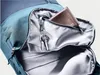 A close-up view of the interior of a backpack, showing a wallet and keys in a zippered pocket. Produktbild-Vorschau