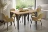 A dining table and chairs set in a modern, well-lit room with a large window overlooking a garden.
