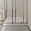 A close-up view of the base of a modern shower enclosure, showing the white shower tray and sliding glass doors. Anteprima dell’immagine prodotto