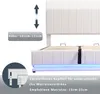 Close-up view of a white upholstered bed frame with LED lighting and adjustable headboard details. Produktbild-Vorschau