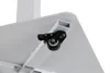 Close-up view of a white desk with a black caster wheel attached to the underside. Podgląd zdjęcia produktu