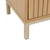 A close-up view of the bottom corner of a wooden cabinet with metal legs. Náhled obrázku produktu