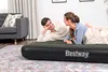 A couple lying on an air mattress in a living room. Náhled obrázku produktu