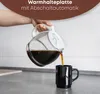 Pouring coffee from a glass carafe into a black mug. Anteprima dell’immagine prodotto