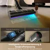 A close-up of a cordless vacuum cleaner head with blue and purple lights illuminating the floor, showing text being revealed. Below are two inset images detailing features. Produktbild-Vorschau