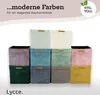 A collection of colorful storage boxes arranged in a grid. Voir les images du produit