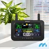 A digital weather station is displayed on a white surface in front of a window with blinds and a potted plant. Podgląd zdjęcia produktu