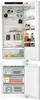 An open built-in refrigerator and freezer combination, showing the interior shelves and drawers stocked with food items. Produktbild-Vorschau