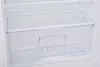 Close-up view of an empty, clear plastic drawer inside a white refrigerator. Produktbild-Vorschau